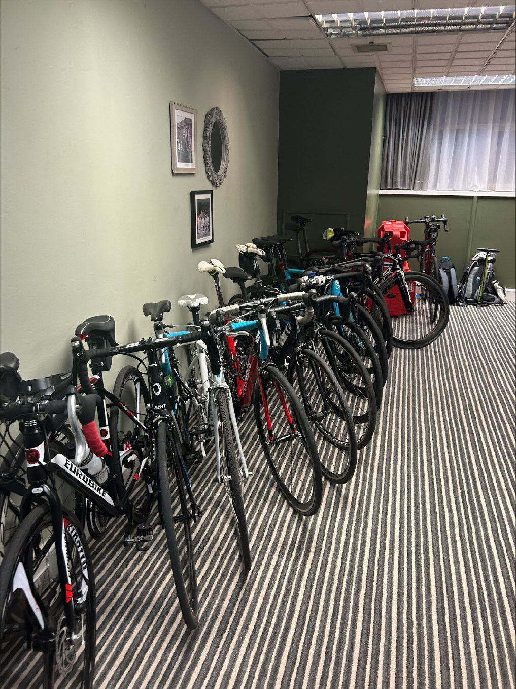A group of bicycles in a roomDescription automatically generated