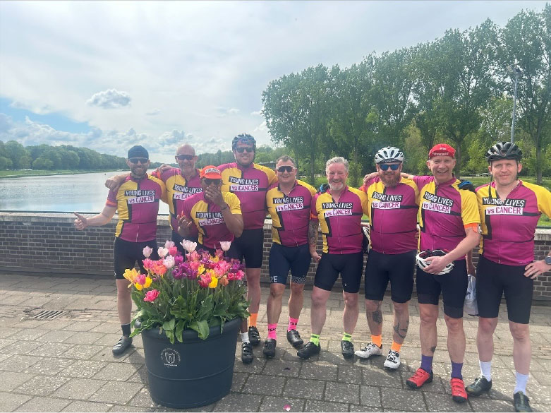 A group of men wearing cycling jerseysDescription automatically generated